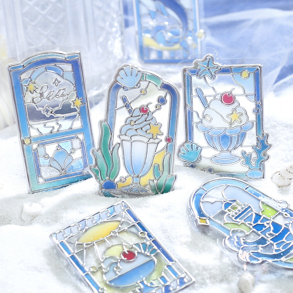 5 blue themed marine stickers with a stained glass design on a snow background