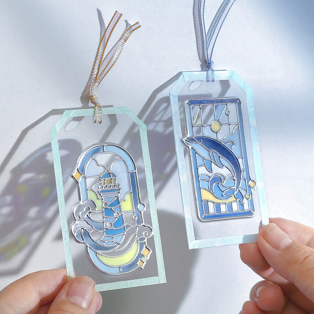 Two blue themed marine stickers on bookmarks with a stained glass design on a white background