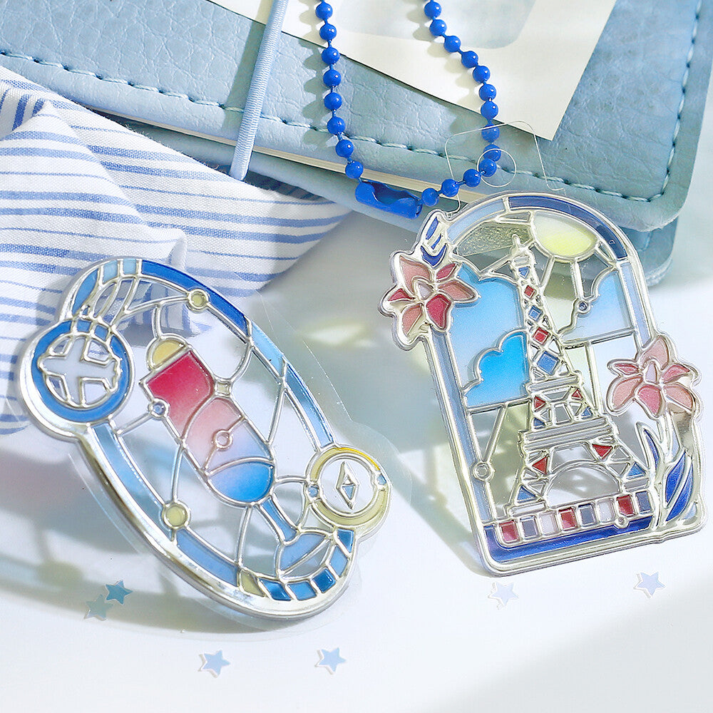Two bookmarks featuring coloured stained glass with scenes of famous buildings over the world on a white background