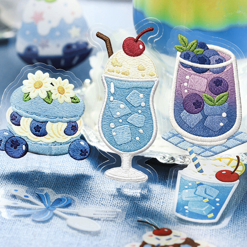 3 blue dessert-themed cake and dessert stickers from BGM Inc. is displayed on a blue cloth background