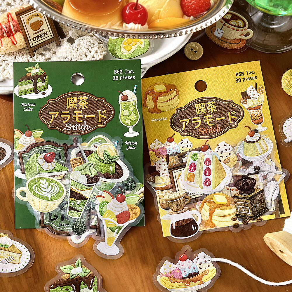 Two packaged sticker sheets labeled 'BOX Inc. Stitch' with Japanese text, shown on a wooden surface.