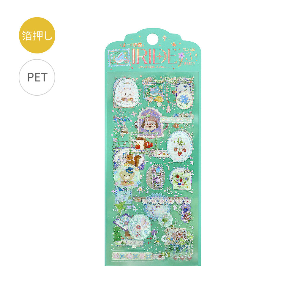 A mint green decorative sticker sheet package labeled 'Iride' with pastel cartoon illustrations and small decorative elements, shown on a white background with two small circular callouts in the upper left.