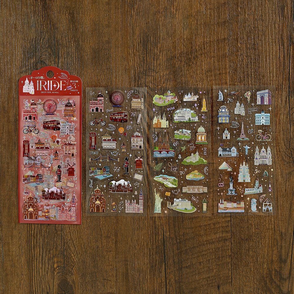 Three sheets of London-themed stickers displayed on a dark wood background, with the red header card of the sheet on the left showing the text 'LONDON TRIP'.