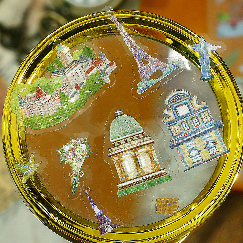 Decorative stickers labeled 'Iride' with pastel cartoon illustrations and small decorative elements, shown on a glass background