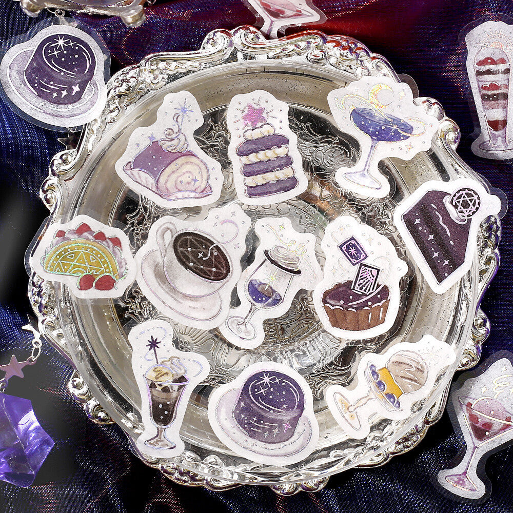Decorative stickers of desserts and drinks on a silver tray with a purple satin background.