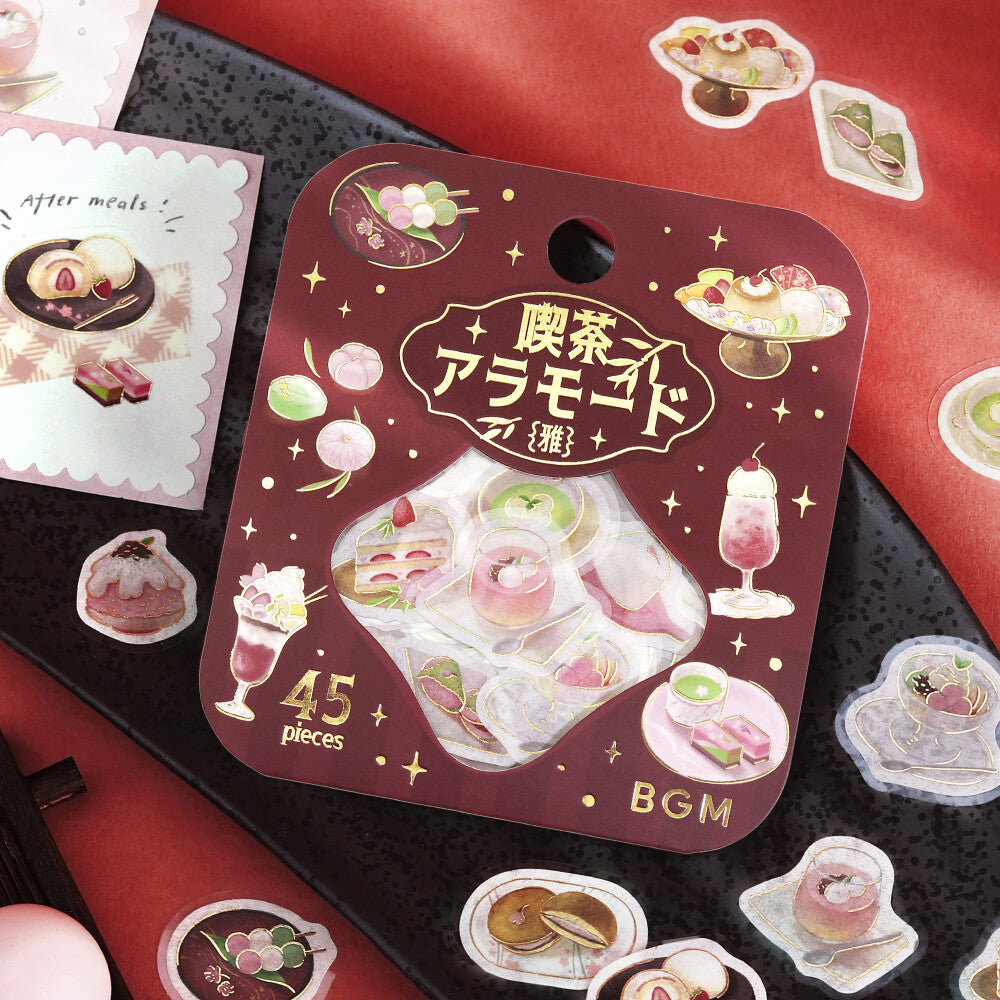 Packaging of dessert-themed stickers with Japanese text on a red and black background.