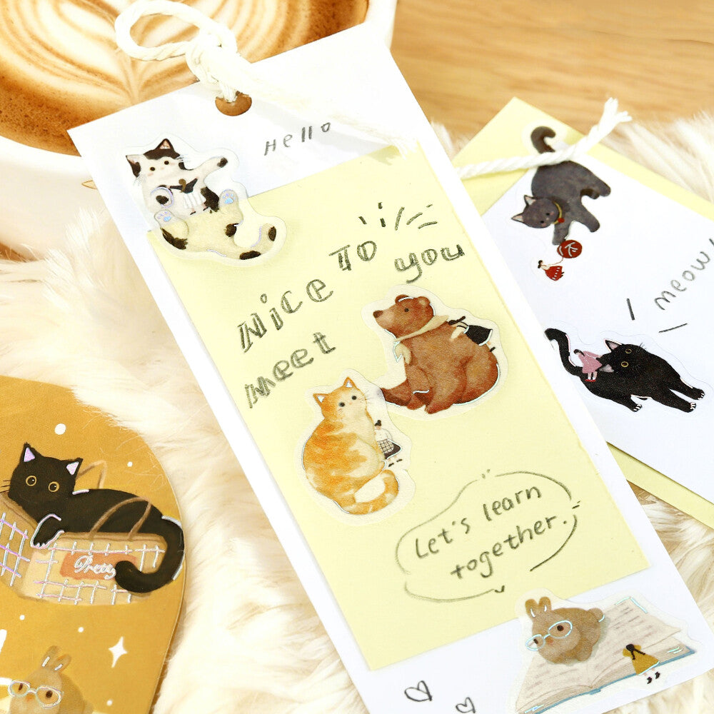 Set of cute animal-themed cards with cartoon illustrations on a wooden surface.