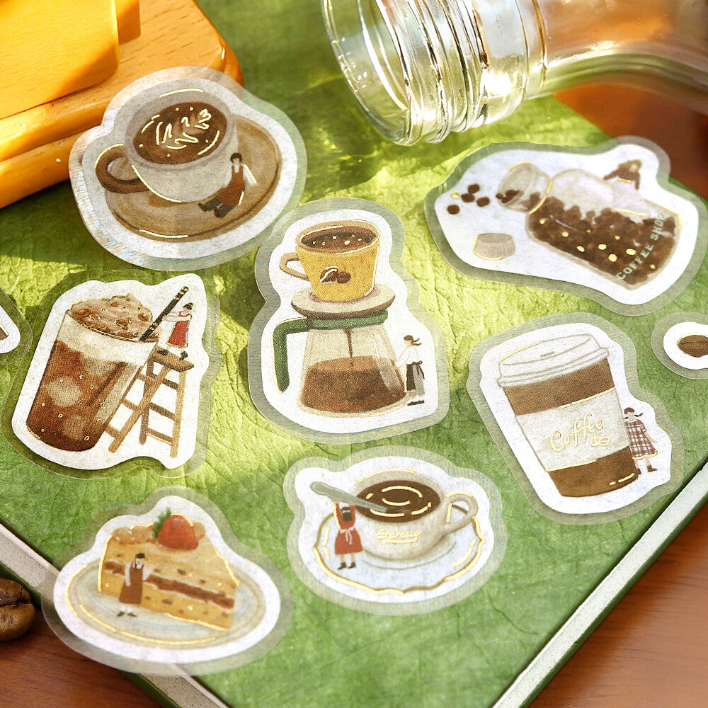 Set of coffee-themed stickers on a green surface with a blurred background