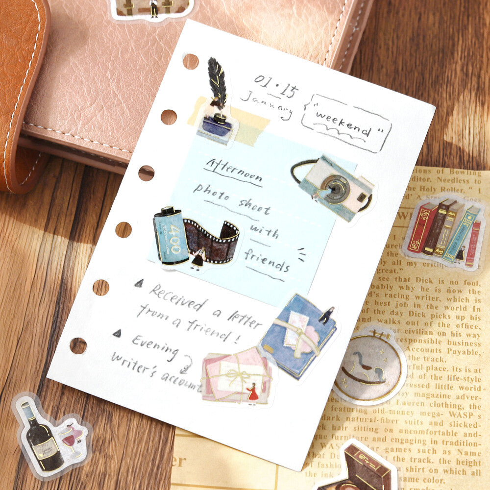 Notebook page with stickers on a wooden surface