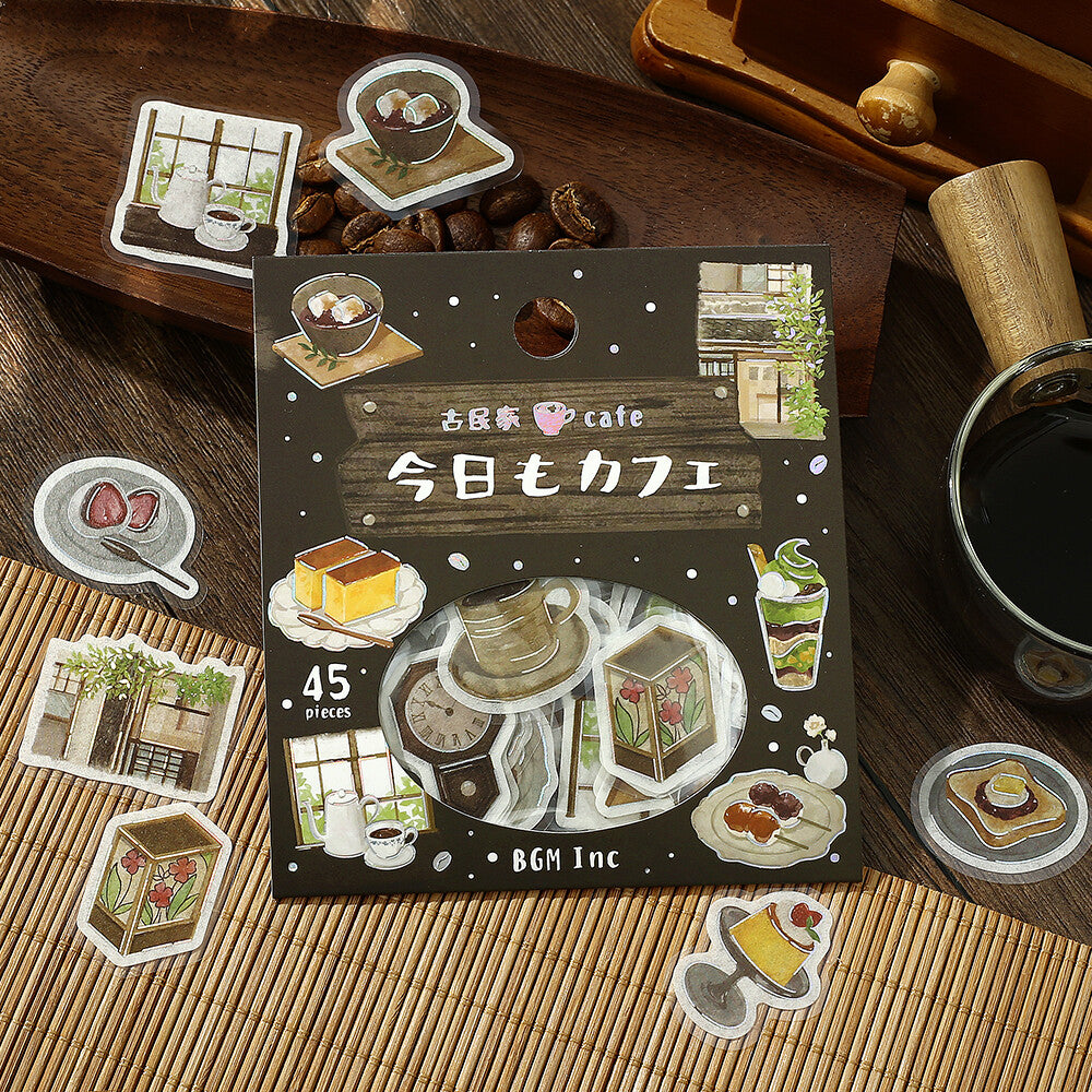 Pack of stickers with coffee-themed designs on a wooden surface with coffee beans and a cup.