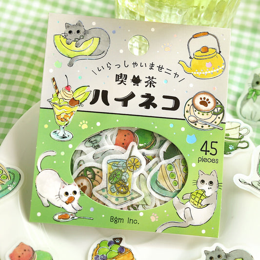 Pack of stickers with cat-themed designs on a green and white checkered background