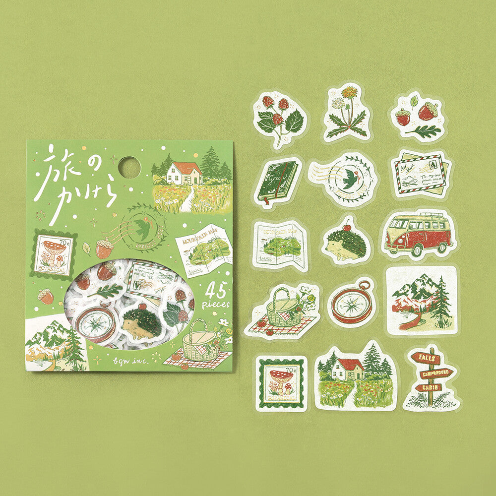 Set of illustrated stickers and a book on a green background