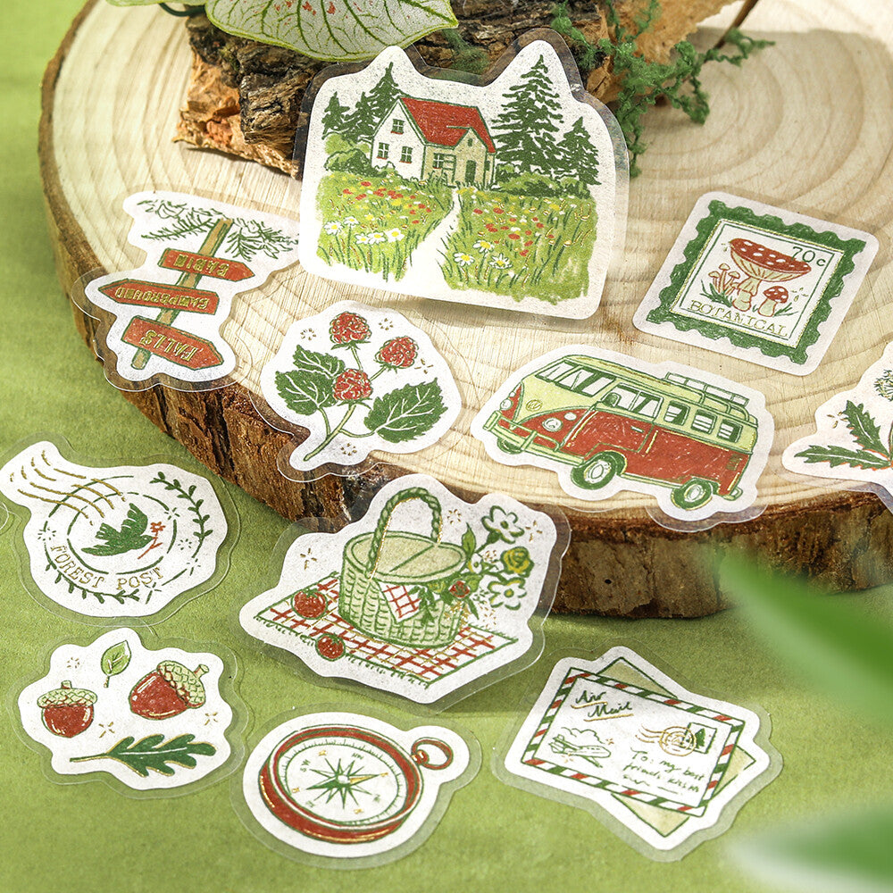 Set of nature-themed stickers on a wooden surface with greenery.