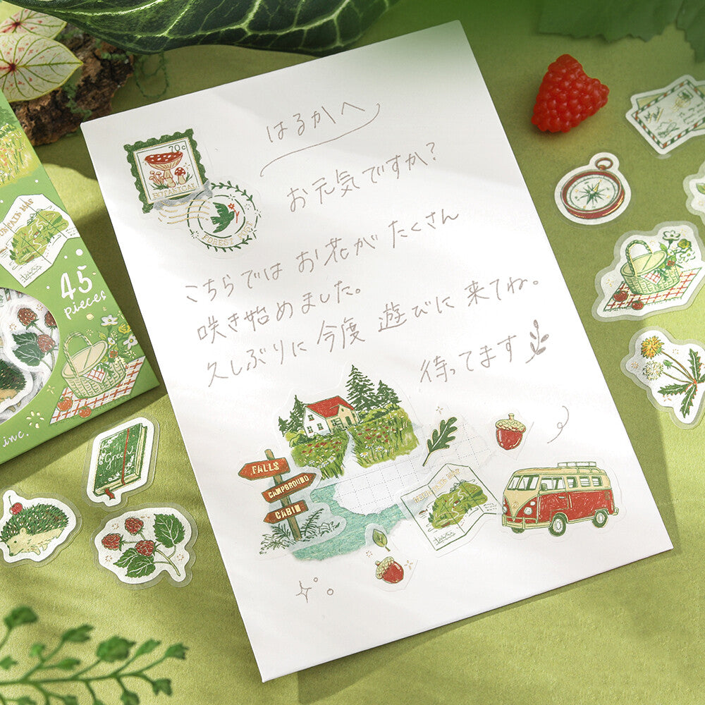Sheet of illustrated stickers with a vintage van, trees, and text on a green surface.