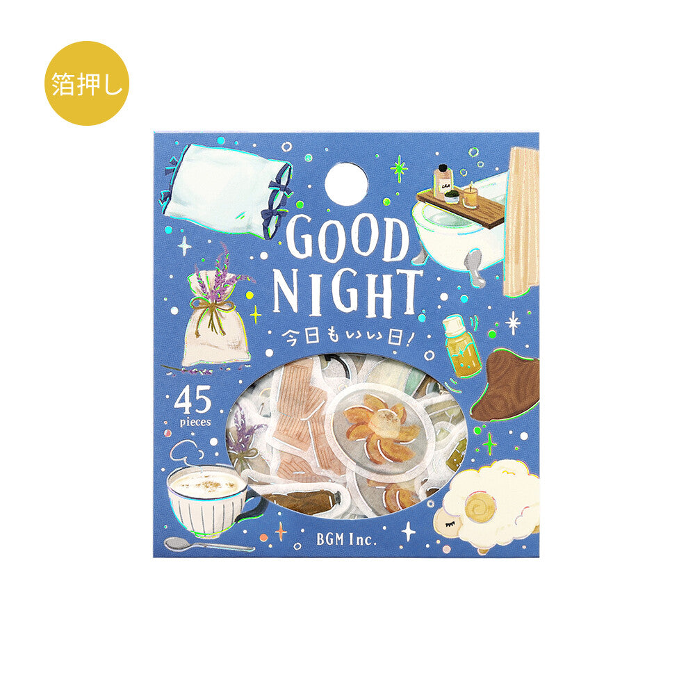A square illustrated product box for a sticker pack with a blue night-sky background, white 'GOOD NIGHT' text, and whimsical drawings of a mug, notebook, bath scene, cup, flower bundle, and cloud. A circular window near the bottom reveals the sticker pieces inside.