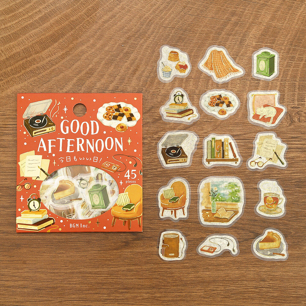 A set of retro themed stickers displayed next to their packaging on a textured wood background. The stickers feature various retro-themed items
