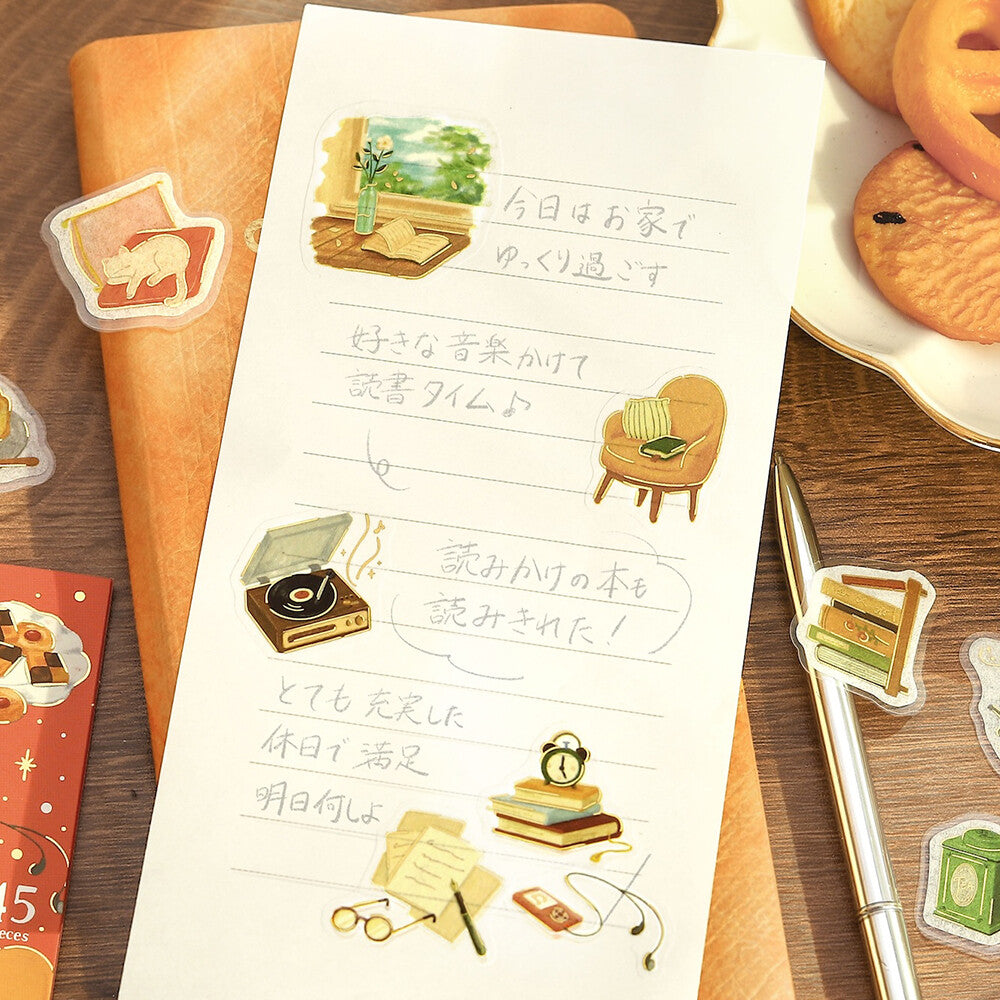 A sheet of paper with stickers used to decorate it on a wooden surface