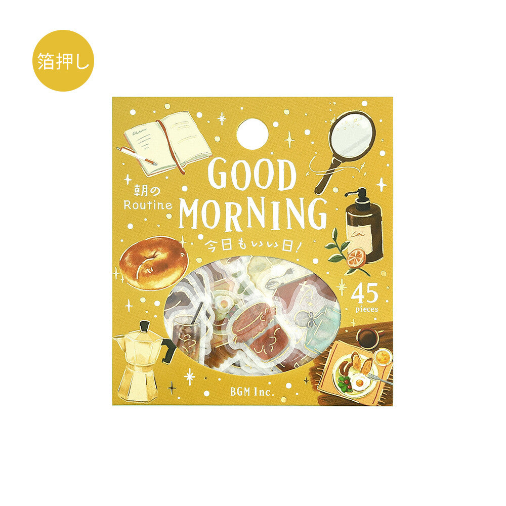 A square yellow product box with illustrated morning-themed graphics and a circular clear window showing small packaged items inside. The box reads 'GOOD MORNING' and '45 times,' with 'BGH Inc.