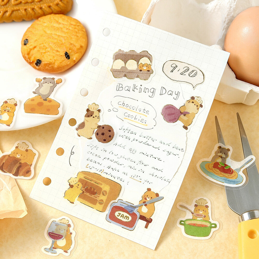 A sheet of paper with surrounding stickers of hamsters cooking and eating on a paper background