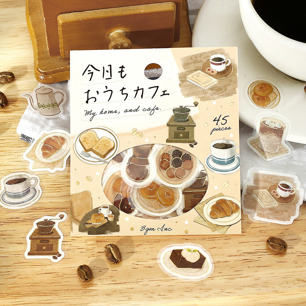 Sticker set with coffee-themed illustrations on a wooden surface.
