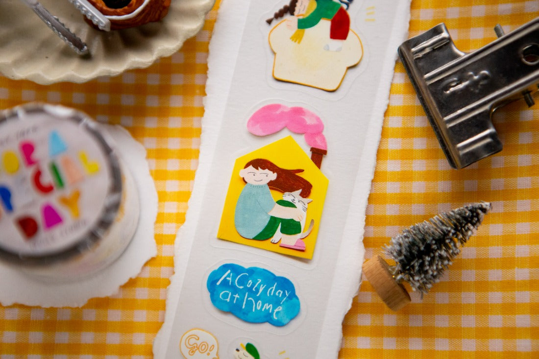 PET stickers adhered on a white paper on a gingham yellow background