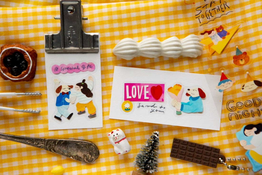PET sticker elements placed together with decorative antiques on a yellow gingham background
