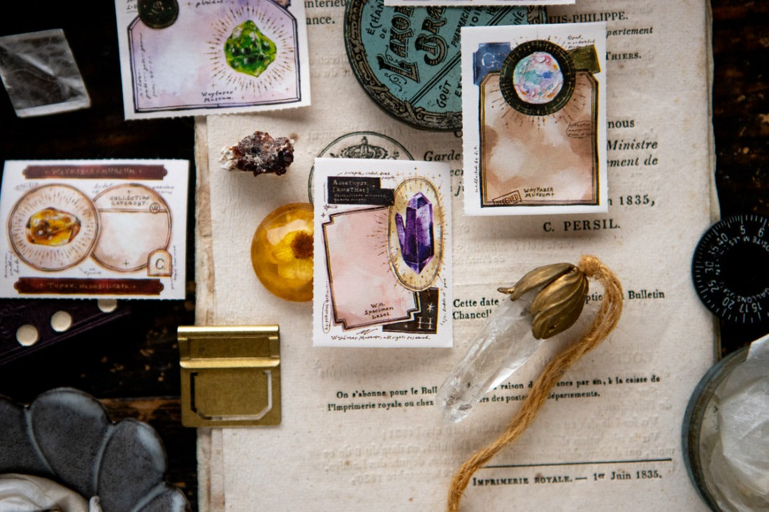 Labels with gem illustrations on a dark book theme background