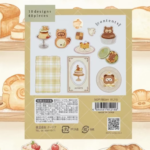 A package of cute Japanese-style stationery stickers by Kuaria, containing 40 pieces with 10 designs. The backing card features a warm beige background with illustrations of a cupcake, a bear, a cup, a cake, and a plaid napkin, along with product details and a barcode.