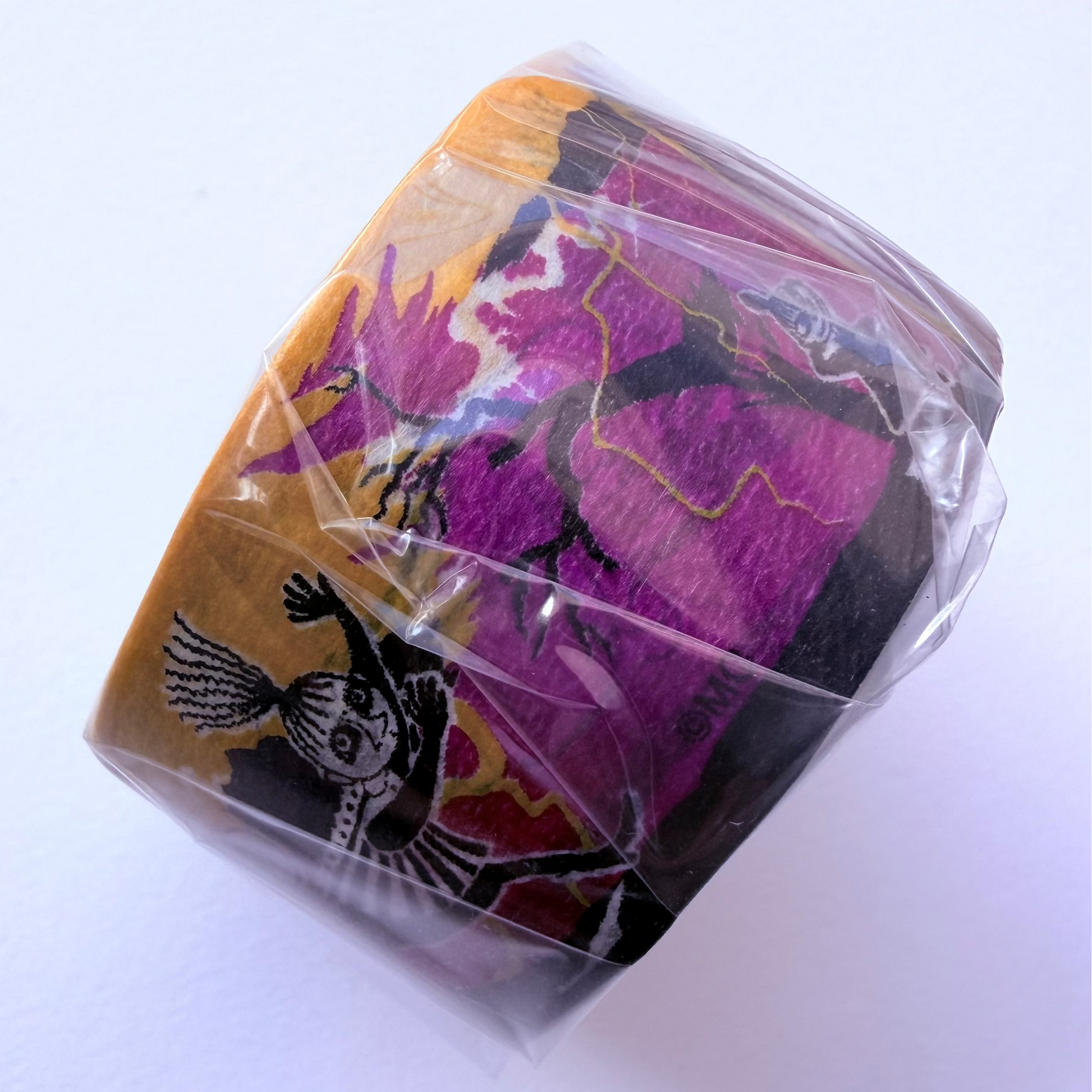 Washi tape roll of Moomins with yellow and purple colours on white background