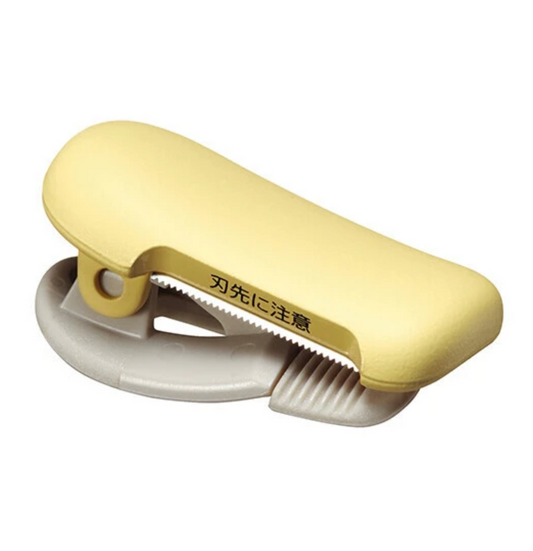 Yellow washi tape cutter on white background