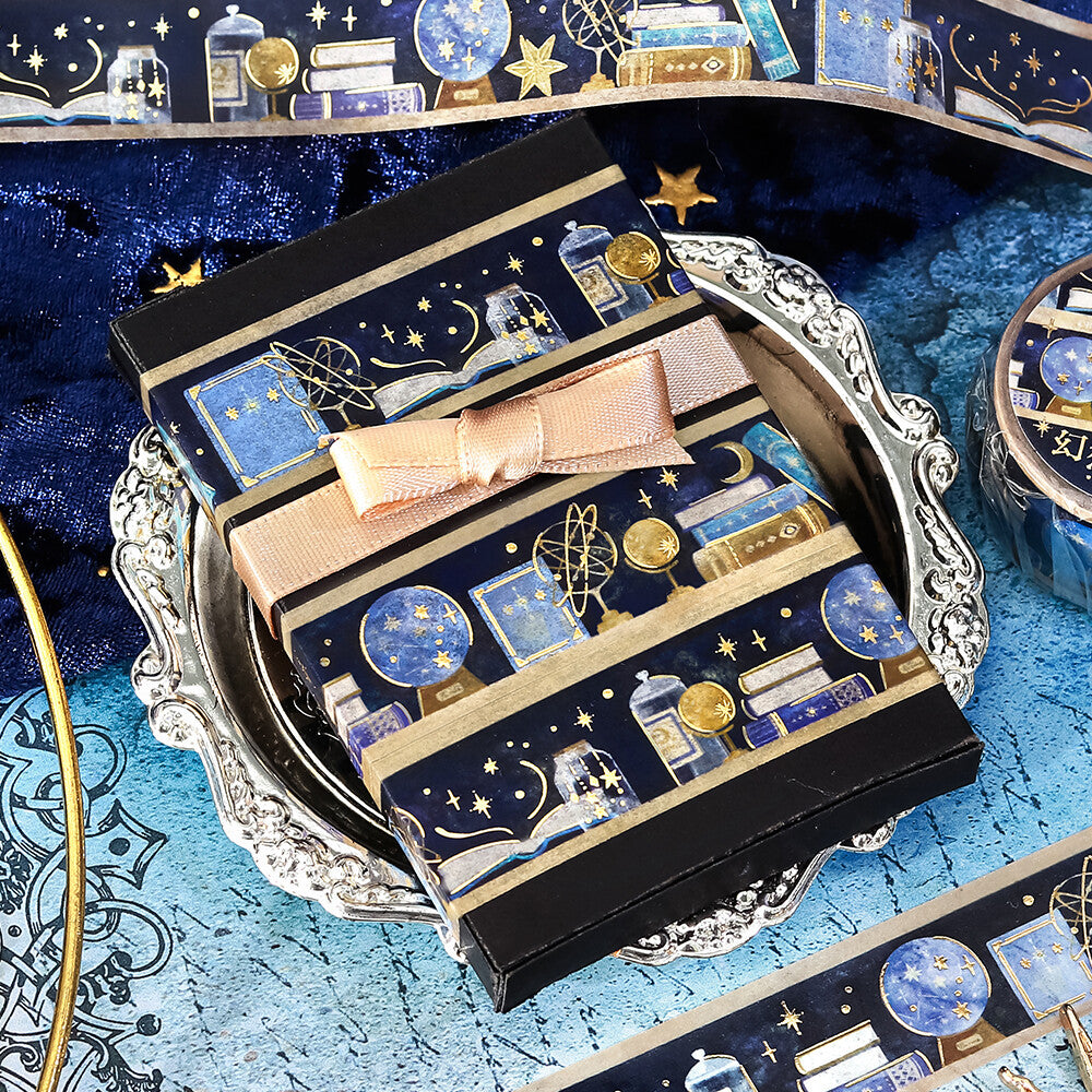 Decorative box with celestial design and pink bow on a blue textured surface