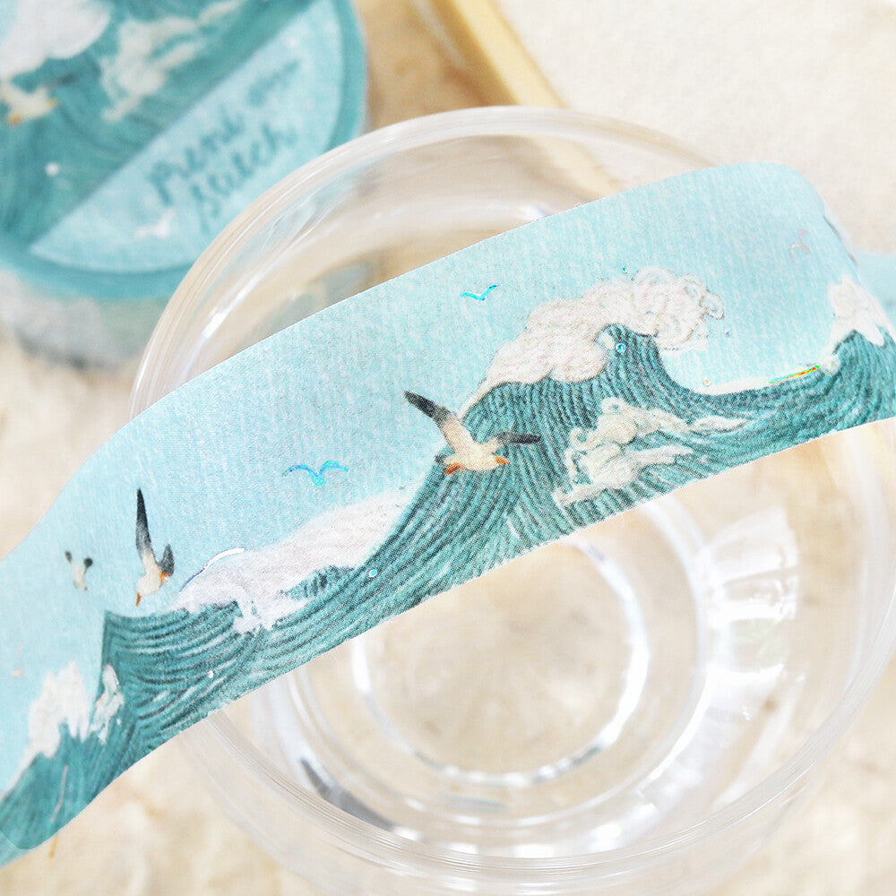 Decorative tape with sea-themed design on a glass surface