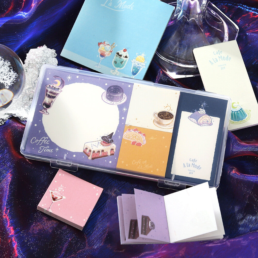 A set of memo pads that are decorated with a purple sparkly coffee theme on a purple background