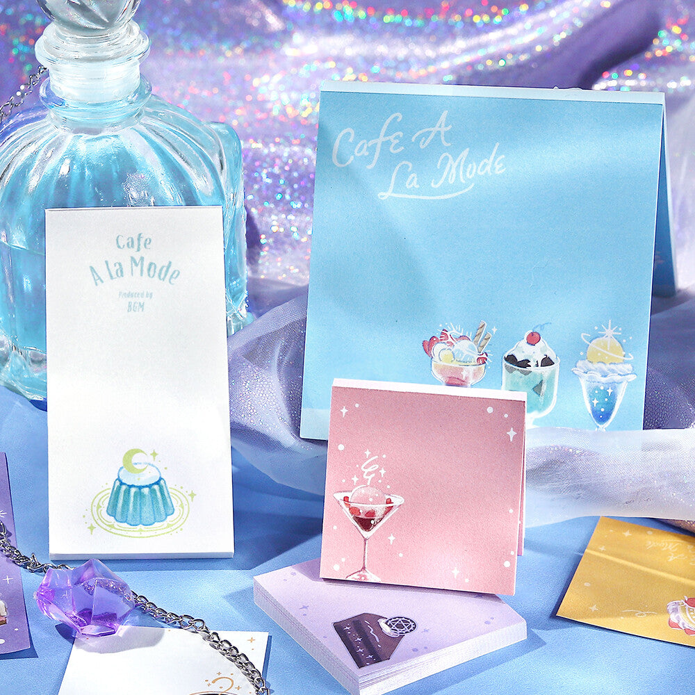 4 decorative memo pads with illustrations on them, against a ornate background
