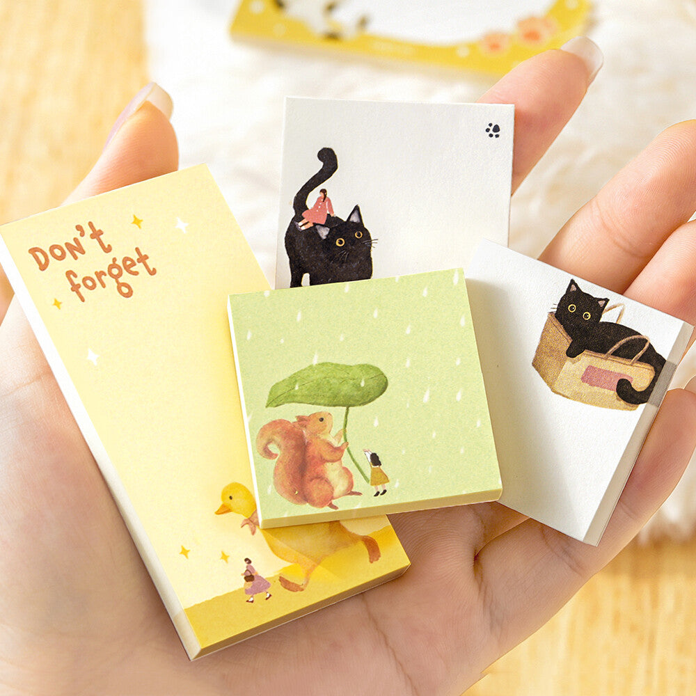A hand filled with memo pads with animal themes