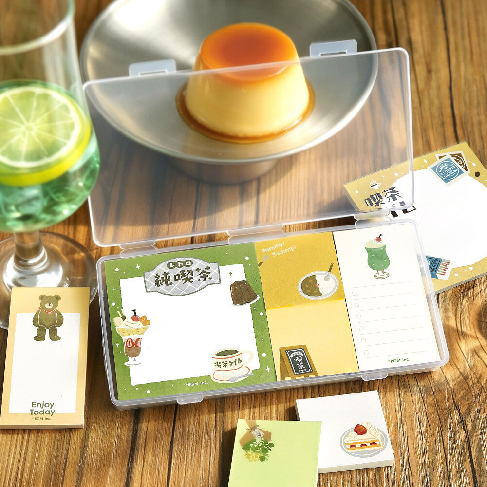 A packet of memo pads decorated with a retro theme and a custard in the background
