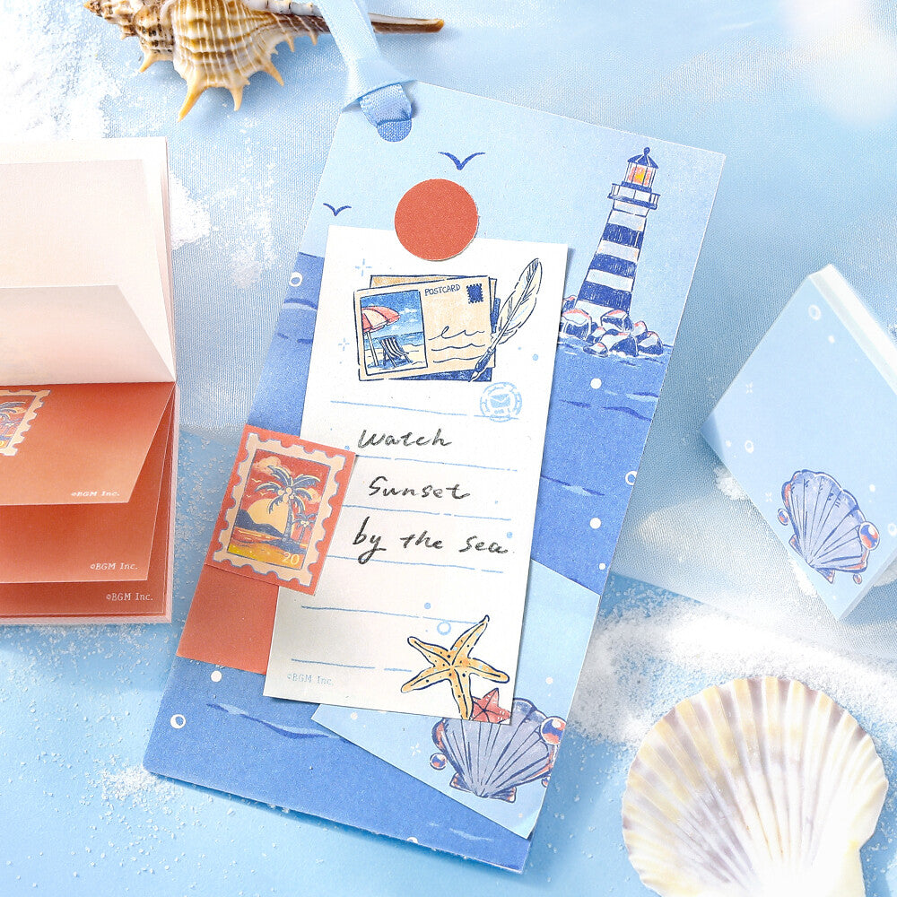 Decorative bookmark with travel themed illustrations on a blue fabric background