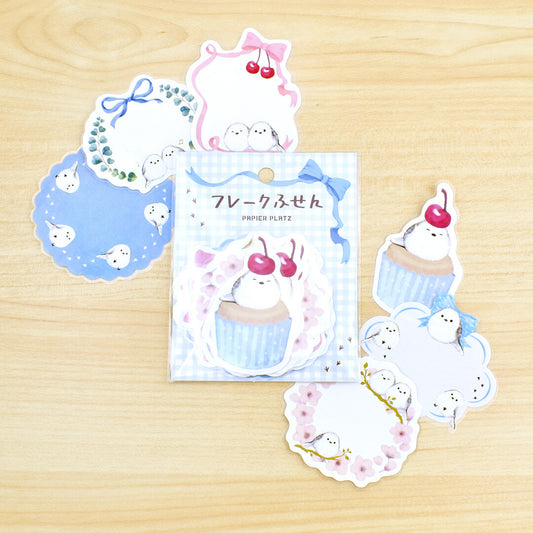 Set of cute animal-themed stickers on a wooden surface