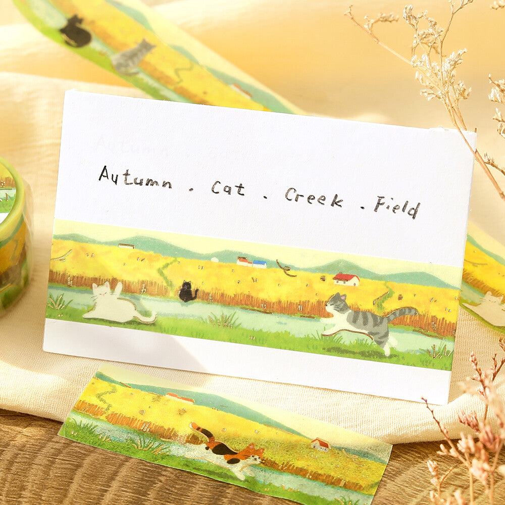 A card with washi tape of cats on a wheat field