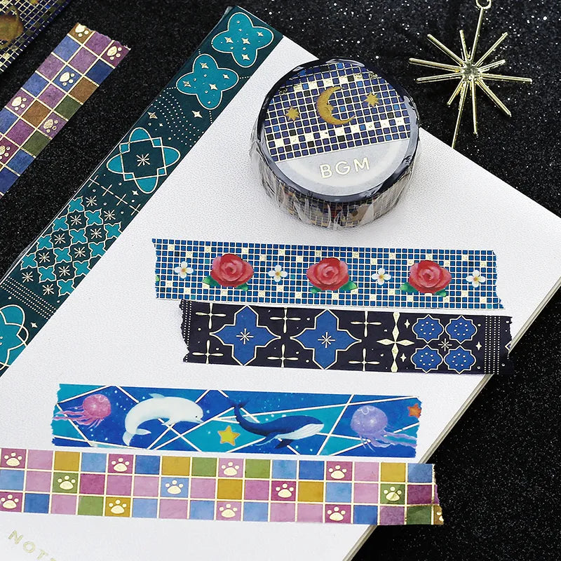 Various washi tapes and their designs on a cloth glitter background