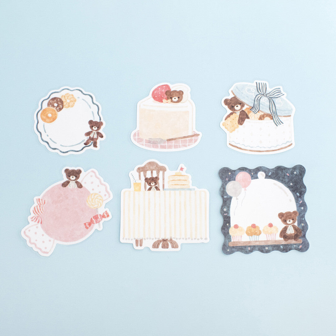 Set of decorative stickers with teddy bears and cakes on a light blue background