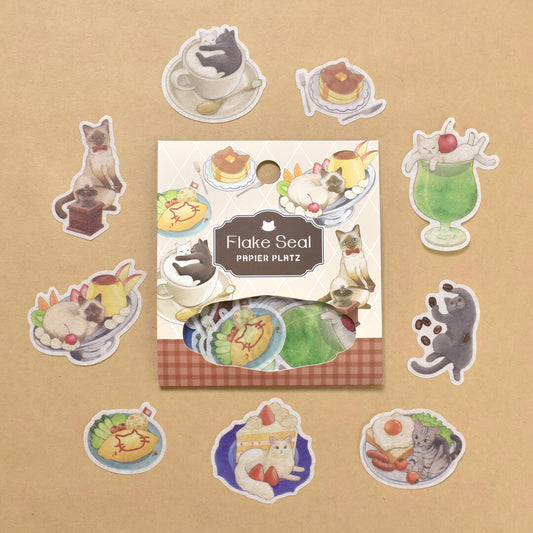 A packet of Flake Seal stcikers by Papier Platz depicting cat illustrations on a tan background