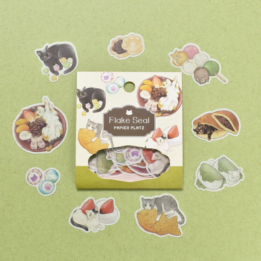 A packet of Flake Seal stcikers by Papier Platz depicting cat illustrations on a green background