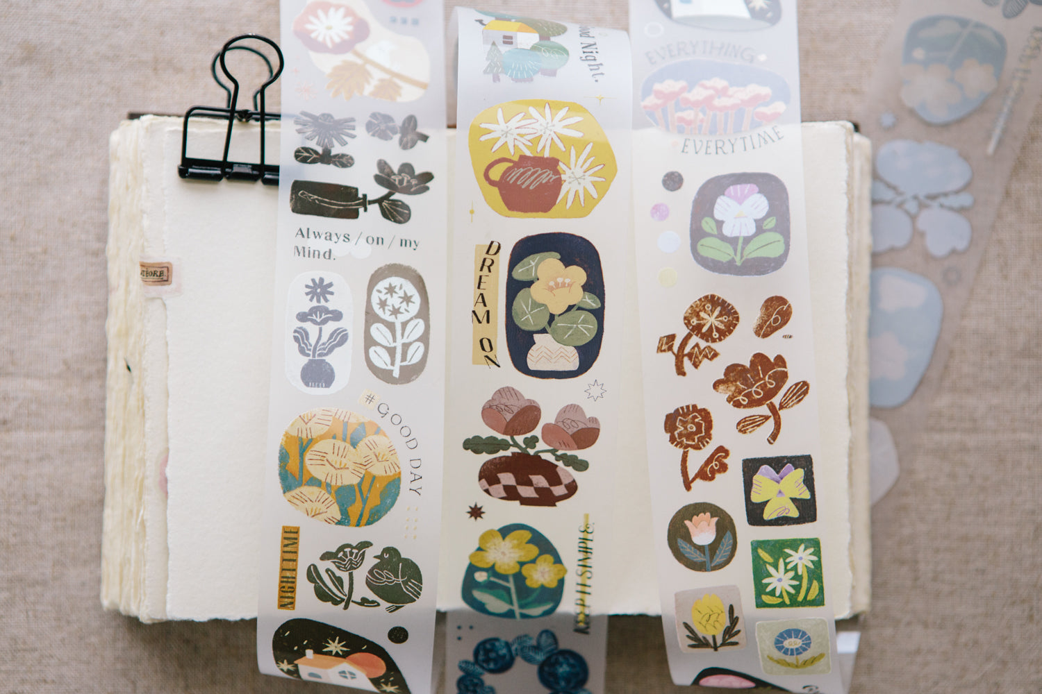 Set of decorative stickers with various designs on a beige surface.