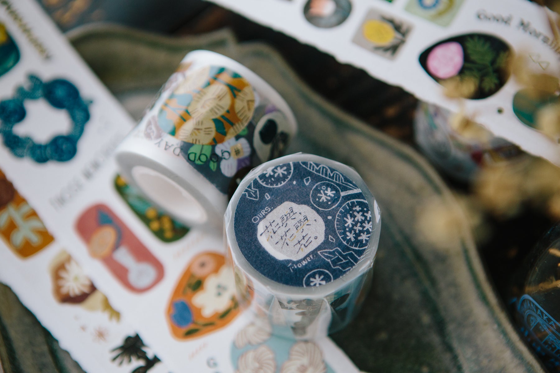 Decorative tape rolls with various designs on a textured surface