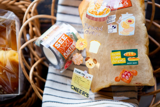 Packaged bread with decorative stickers on a woven basket background