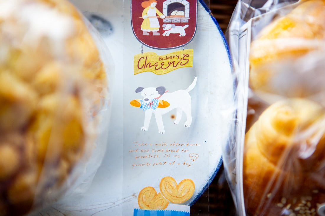 Baked goods in clear packaging with a label featuring a cartoon dog and text.