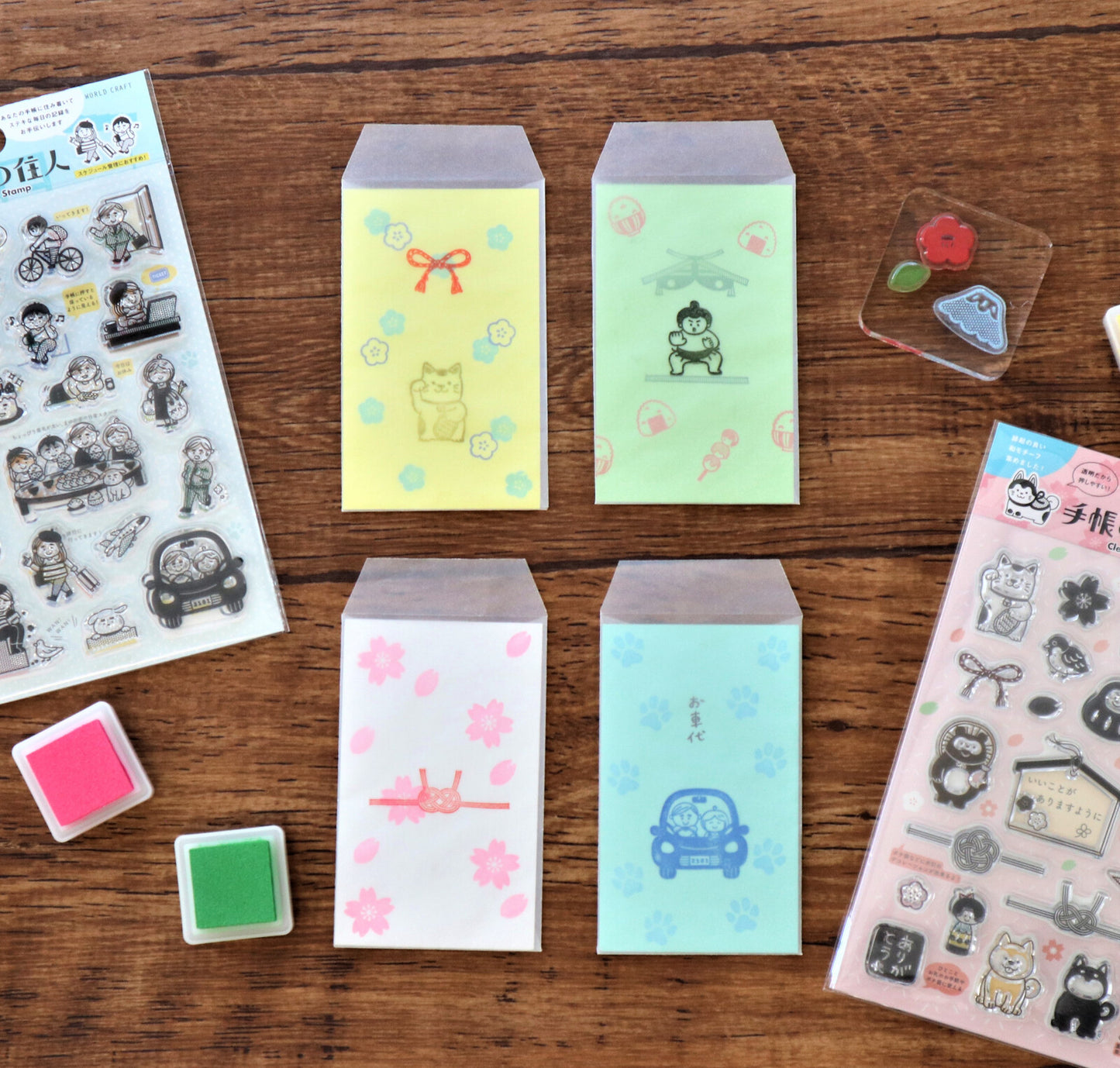 Colorful small envelopes with printed designs on a wooden surface