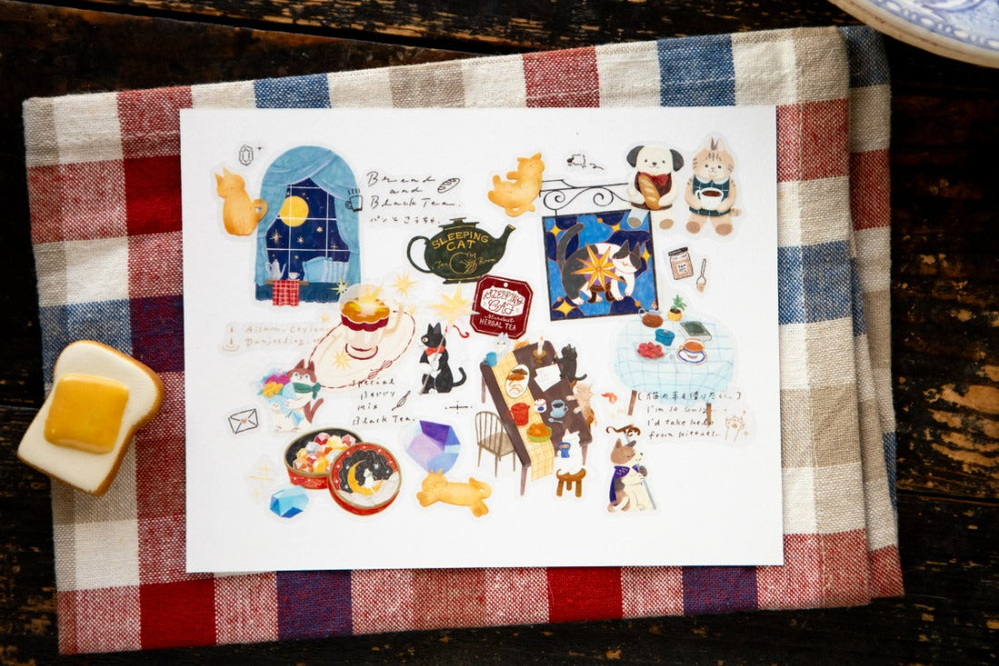Stickers of cat illustrations on a tea towel