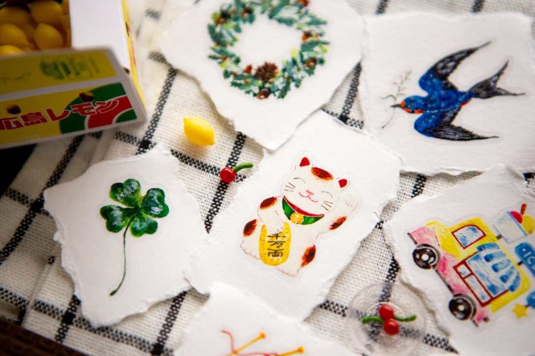 Torn up pieces of paper with PET sticker designs on them
